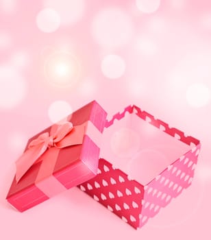 red gift box with hearts on bukeh background