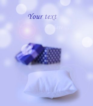 blue jewellery box with ribbon in bukeh background with little pillow to put your ring on