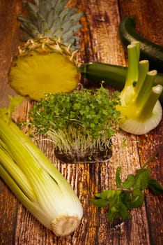 fresh organic vegetables and fruit variety on wooden floor