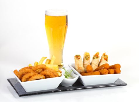 Beer and fried calamar chips and rolled vegetables