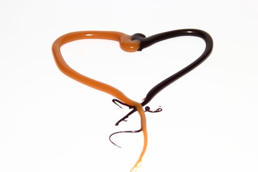 heart of caramel and chocolate on a white background as a symbol of love