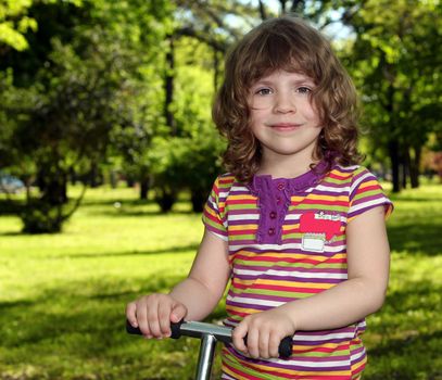 beautiful little girl in park portrait