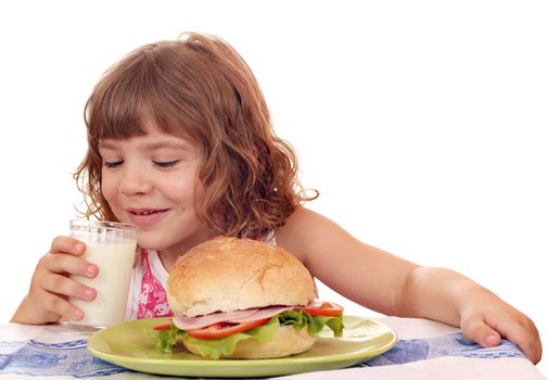 little girl eat sandwich and drink milk