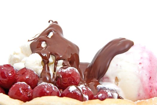 closeup of delicious dessert with  ice cream , chocolate sauce and cherries over white background