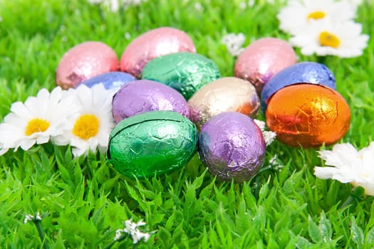 colorful easter eggs in plastic grass in closeup