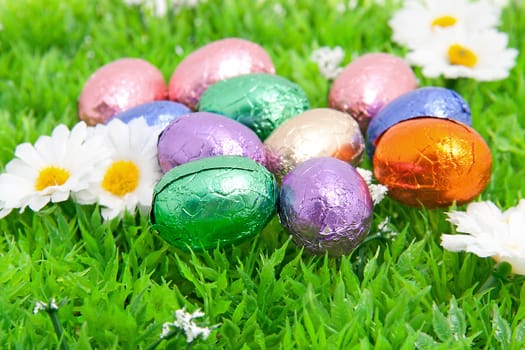 colorful easter eggs in plastic grass in closeup