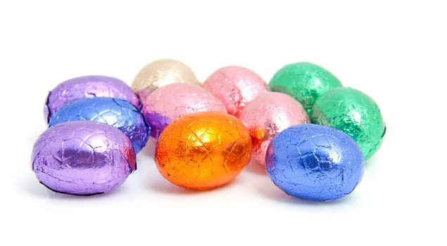 colorful chocolate easter eggs over white background