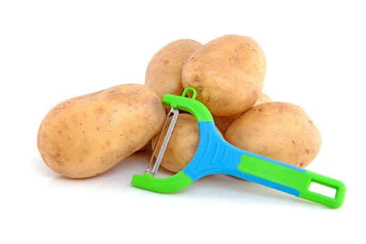 Stack of unpeeled potatoes with colorful peeling knife isolated on white background