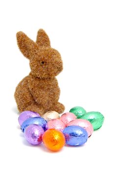 Brown bunny and easter eggs over white background