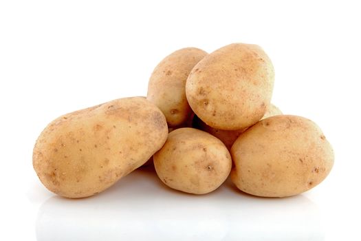 Stack of unpeeled potatoes isolated on white background 
