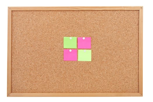 Blank sticky notes pinned on cork memo board in closeup over white background