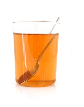 cup of thee with spoon over white background
