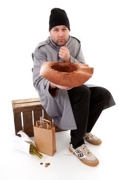 social issue; homeless beggar holding hat for money over white background
