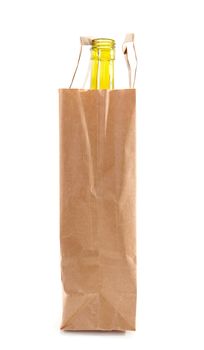 paper bag with bottle inside over white background