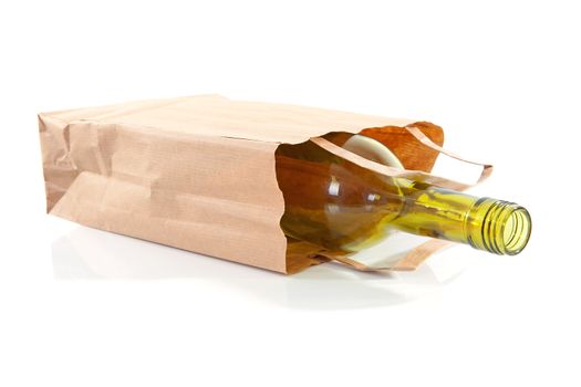 paper bag with bottle inside over white background