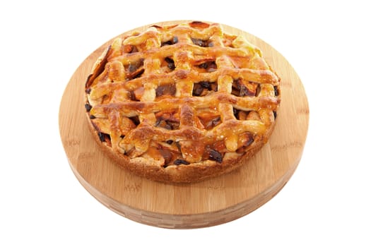 Delicious home baked apple pie on wooden cutting board isolated on white background