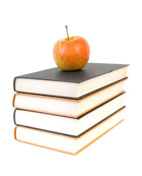 back to school: stack of books with apple on top over white background