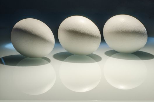 Three eggs still-life on glas