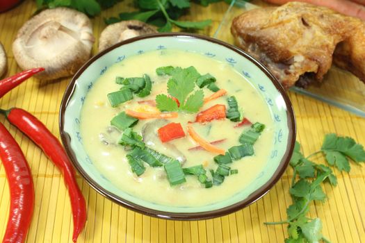 Curry soup with chicken, bell peppers, coconut milk, red pepper and Shiitake mushrooms