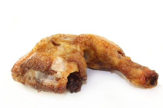 a grilled chicken leg against white background