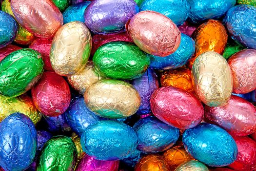 colorful chocolate easter eggs in closeup can be used as background 

