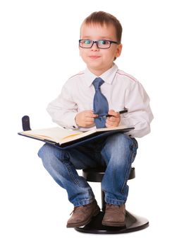 Small clever kid with organizer notebook and pen looking in camera. Isolated on white background.