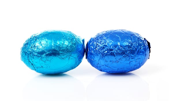 Two blue easter eggs over white background