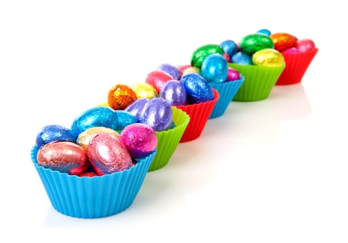 colorful bowls with easter eggs over white background