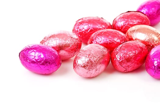 Pile of pink easter eggs over white background