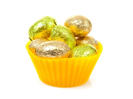 yellow bowl with easter eggs over white background