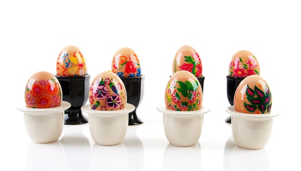 chicken eggs decorated by children for easter in  holder over white background