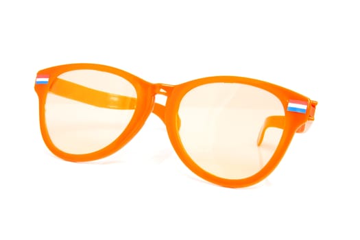 One big orange glasses with Dutch flags over white background
