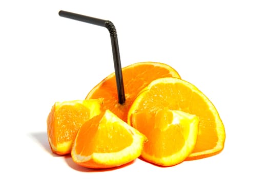 fresh slices of orange with black straw over white background