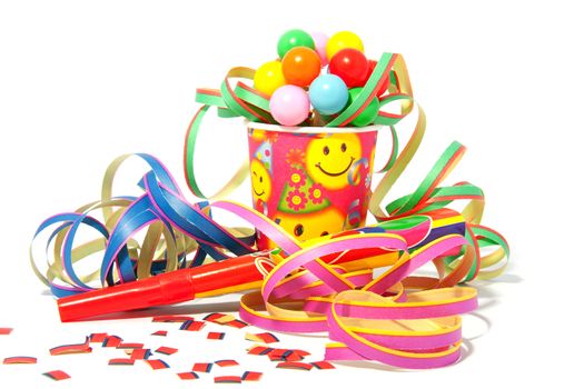 colorful party accessories with streamers over white background