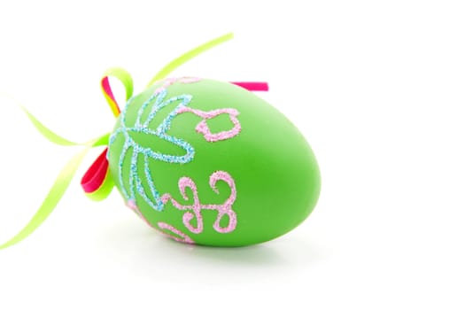 green decorated easter egg over white background