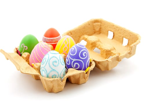 Six colorful easter eggs in box over white background