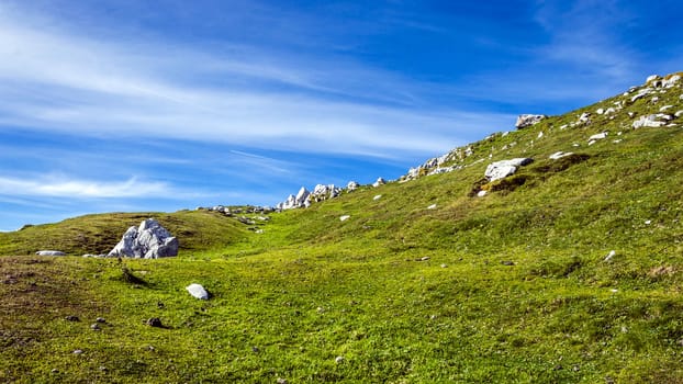 Rocky mountain terrain with fine grass and beautiful sky.