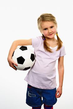 Cute girl playing football, happy child, young female goalkeeper enjoying sport game, holding ball, isolated portrait of a preteen smiling and having fun, kids activities, little footballer 