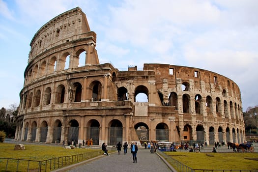 tourists for the colosseum in Rome against blue sky