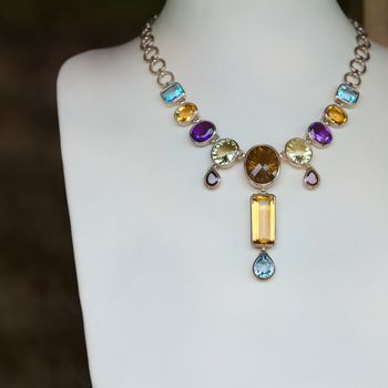 Necklace with many colored precious jewel (opals, sapphires), shallow depth of field