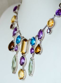 Necklace with many colored precious jewel (opals, sapphires), shallow depth of field