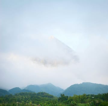 Volcano mount Merapi, Gunung Merapi in clouds - the most active volcano in Indonesia and has erupted regularly since 1548.