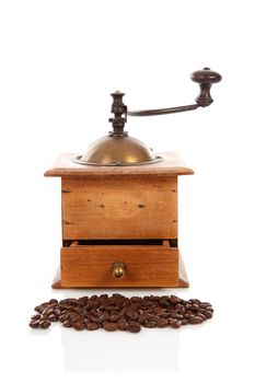 Old wooden coffee grinder over white background