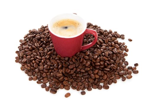 red coffee cup and beans over white background