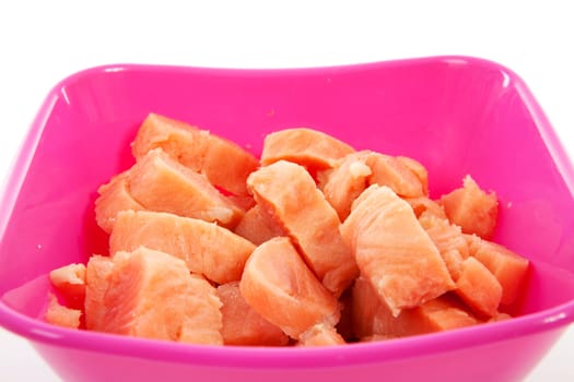 bowl with cubes raw salmon over white background
