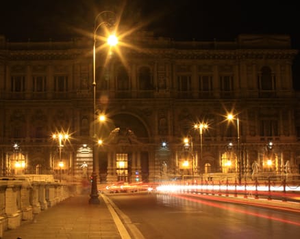 rome at night time with car light trail