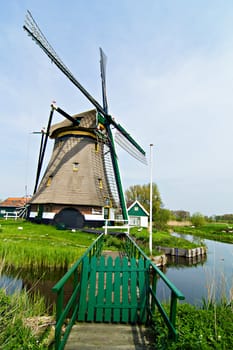 Landscape in Holland with windmills and a canal.