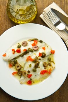 sea bream fillet with tomatoes, green olives and capers