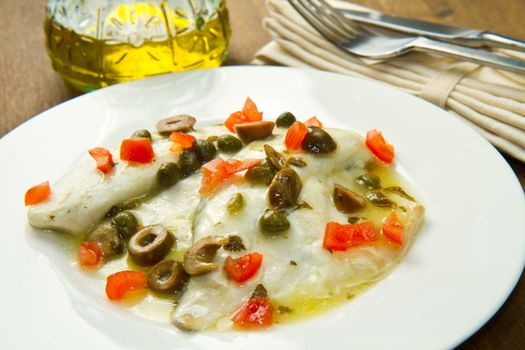 sea bream fillet with tomatoes, green olives and capers