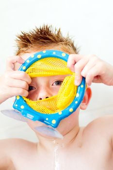 A cute little boy playing in the bath